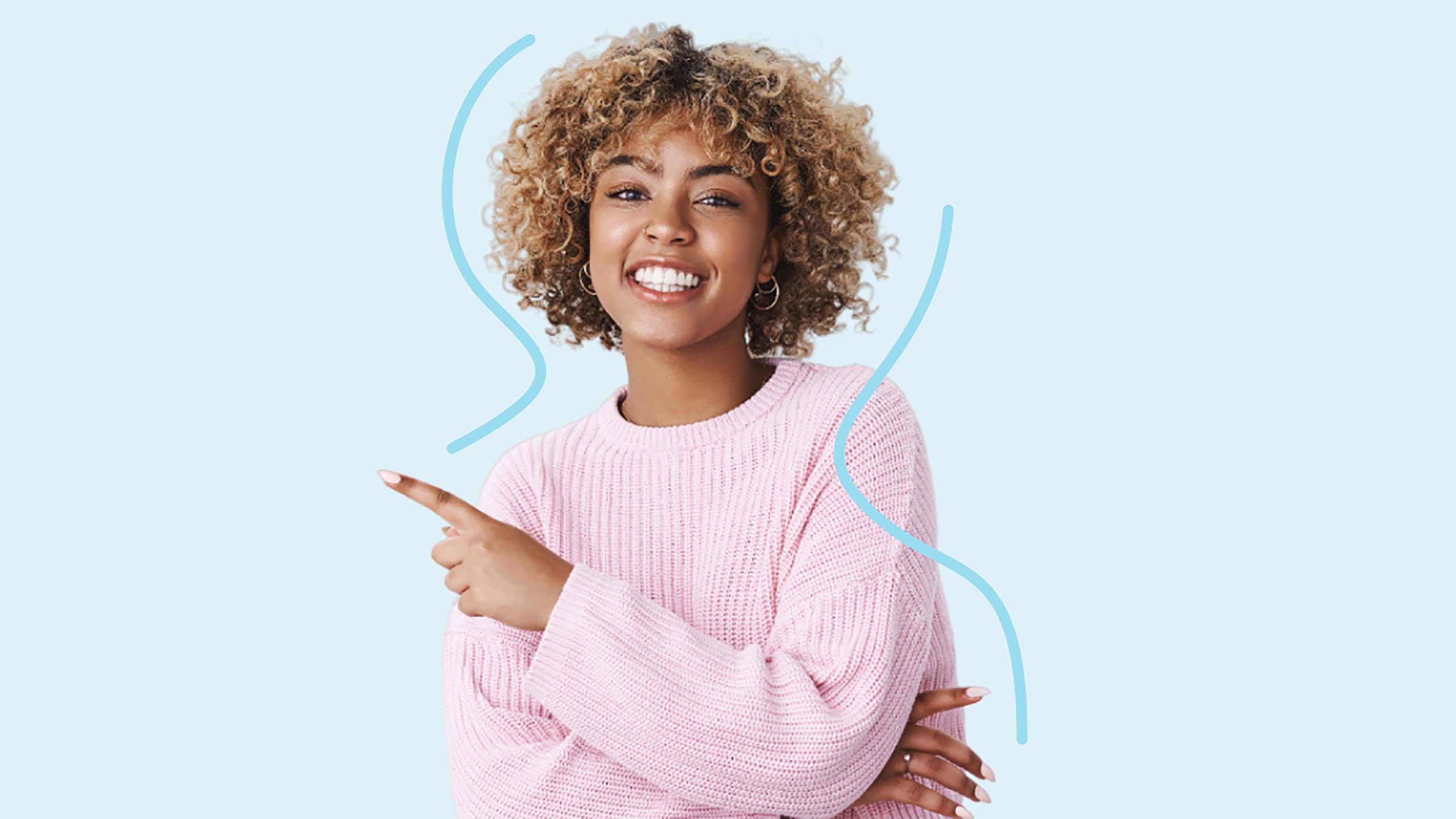 Smiling woman with curly hair pointing